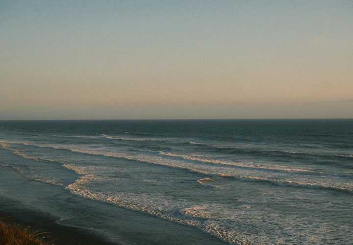 Gentle waves rolling onto a beach at dusk
